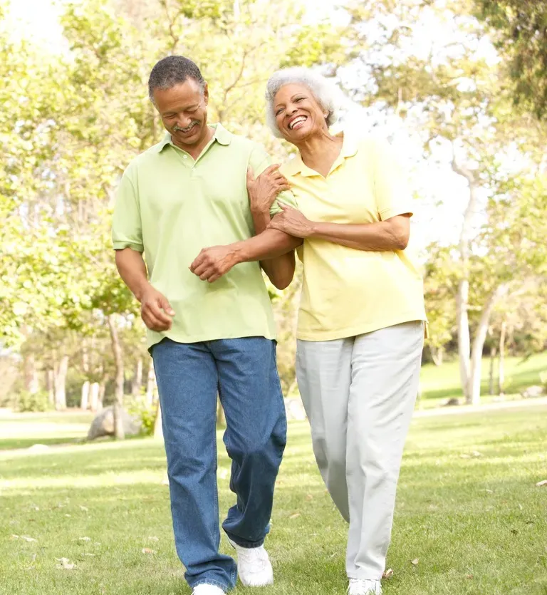 Happy elderly couple walking together on a sunny day